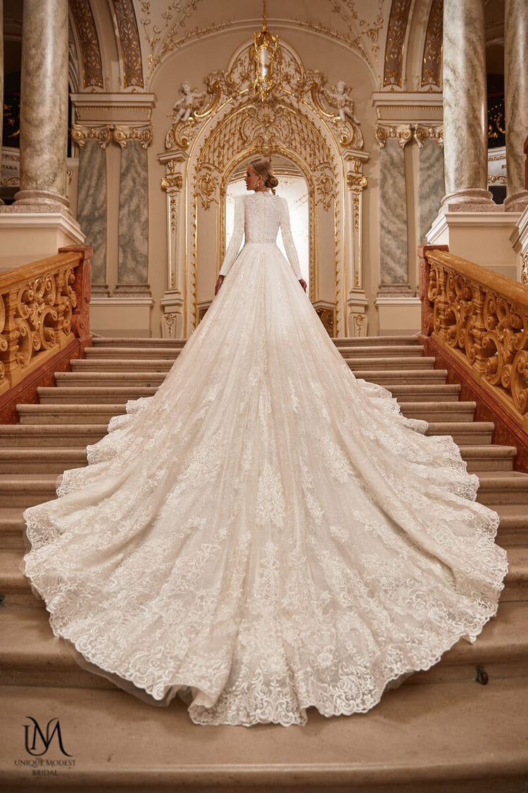 Bride in a grand wedding dress on stairs